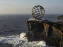 The iconic steel globe monument at North Cape cliff edge over the Arctic Barents Ocean